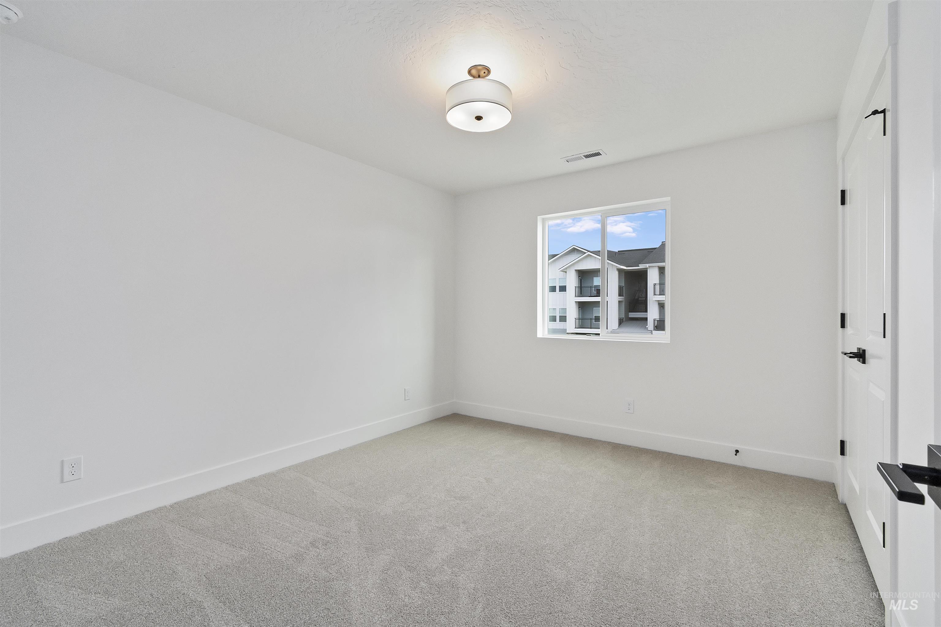 764 South Calhoun Lane Star, ID 83669 - Photo 35 of 48 Unfurnished room featuring light carpet and baseboards