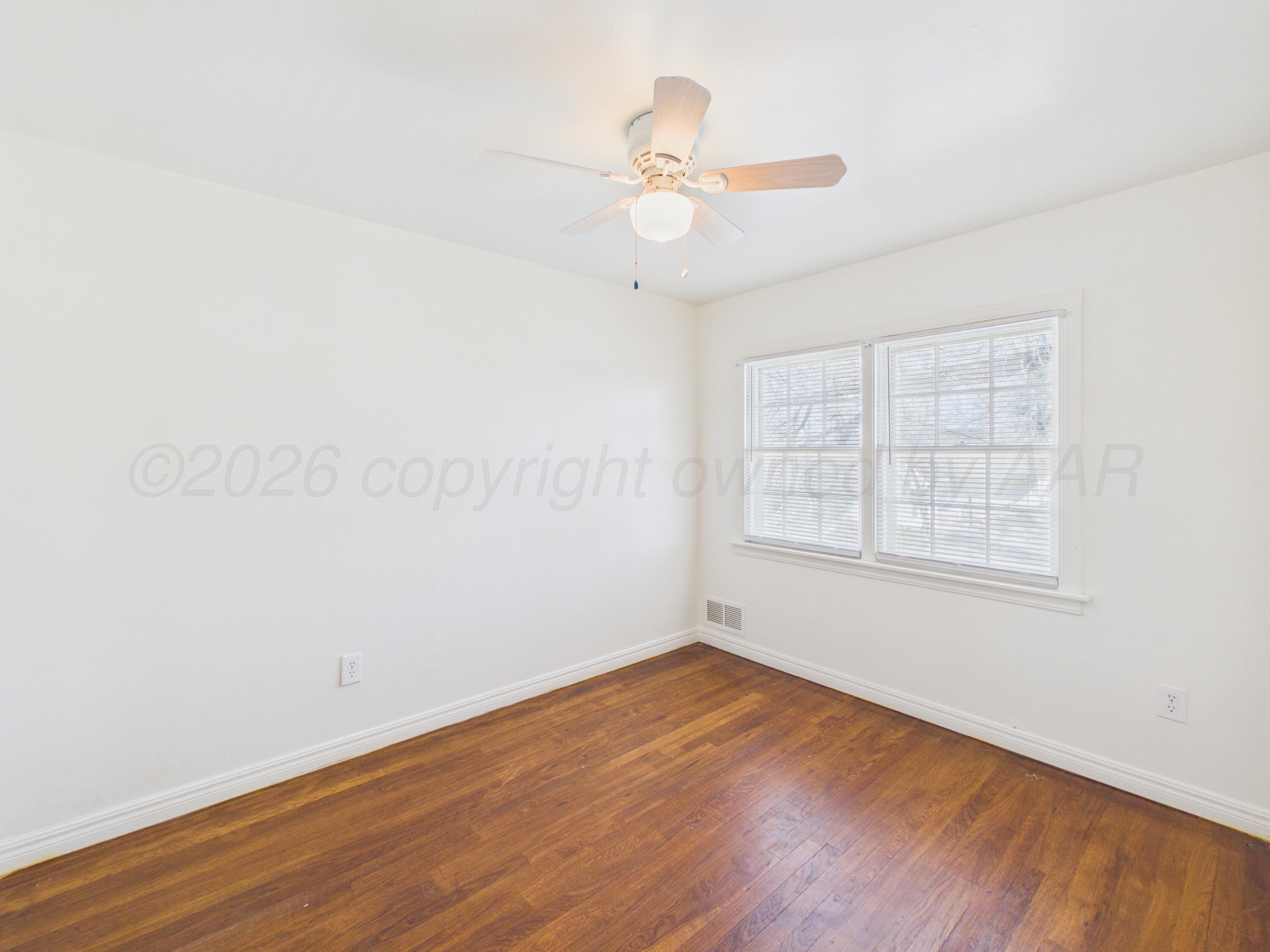 412 Southwest 17th Avenue Amarillo, TX 79102 - Photo 16 of 22 an empty room with wooden floor fan and windows