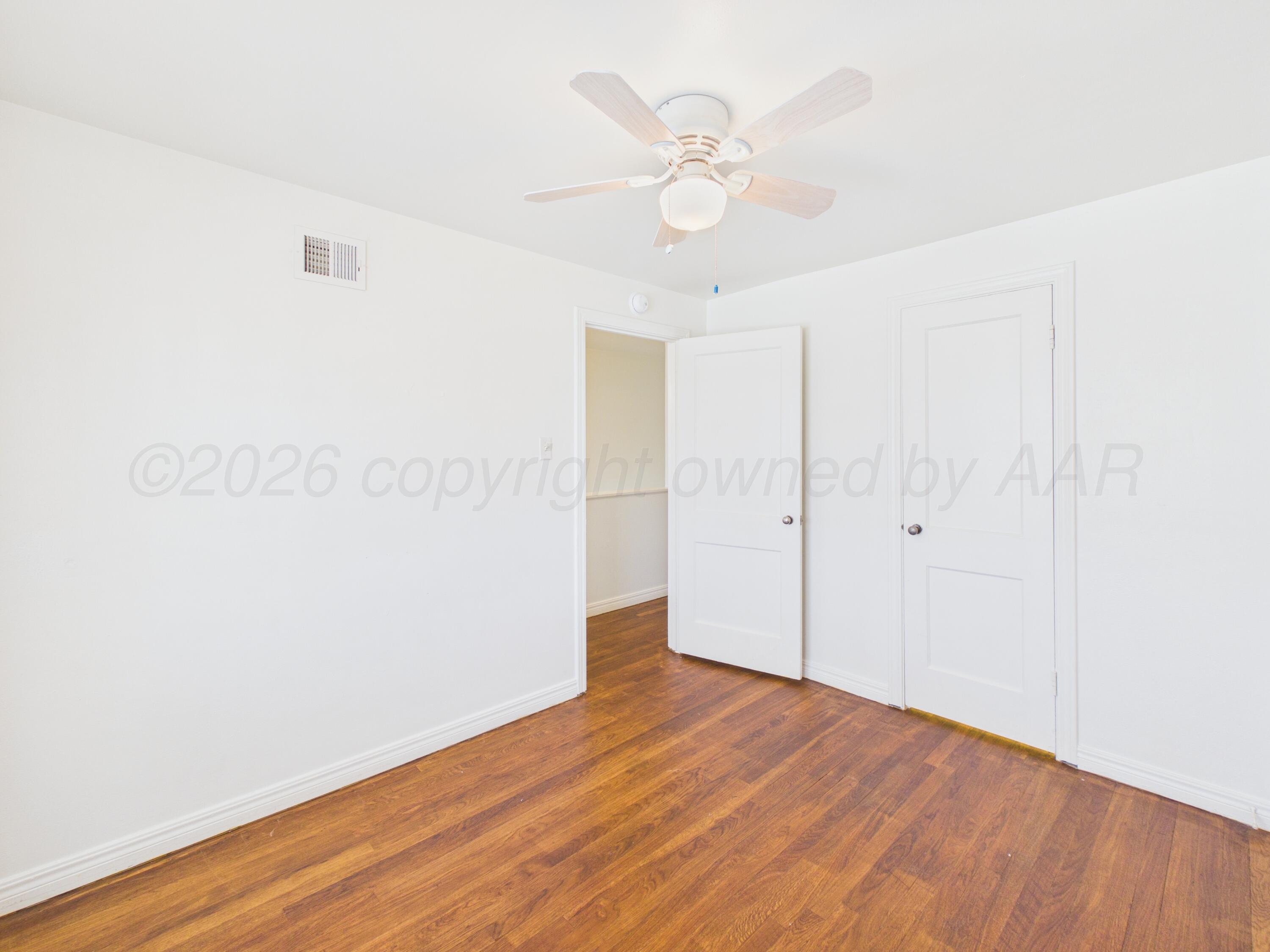 412 Southwest 17th Avenue Amarillo, TX 79102 - Photo 17 of 22 an empty room with wooden floor and fan