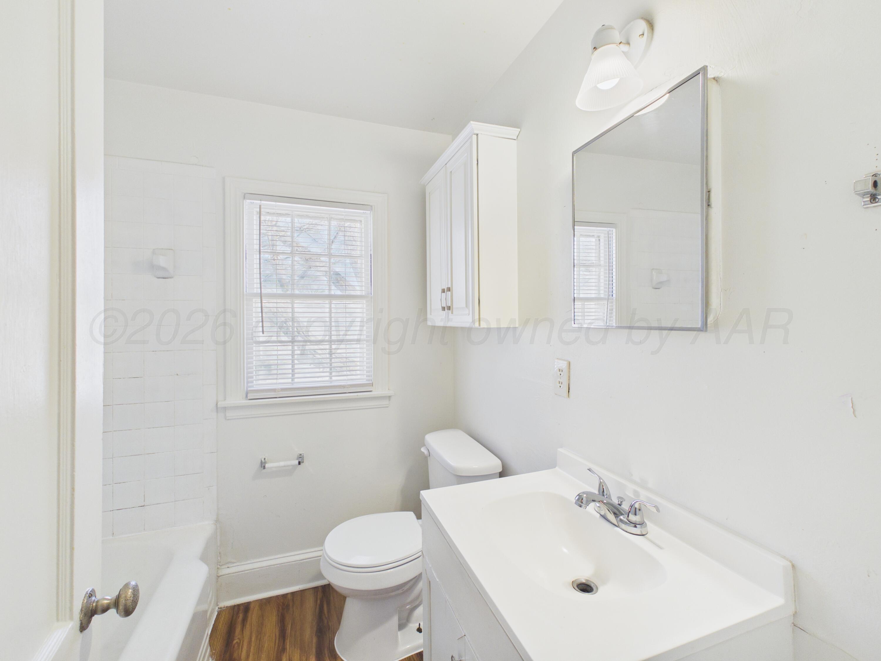 412 Southwest 17th Avenue Amarillo, TX 79102 - Photo 19 of 22 a bathroom with a sink toilet and a mirror