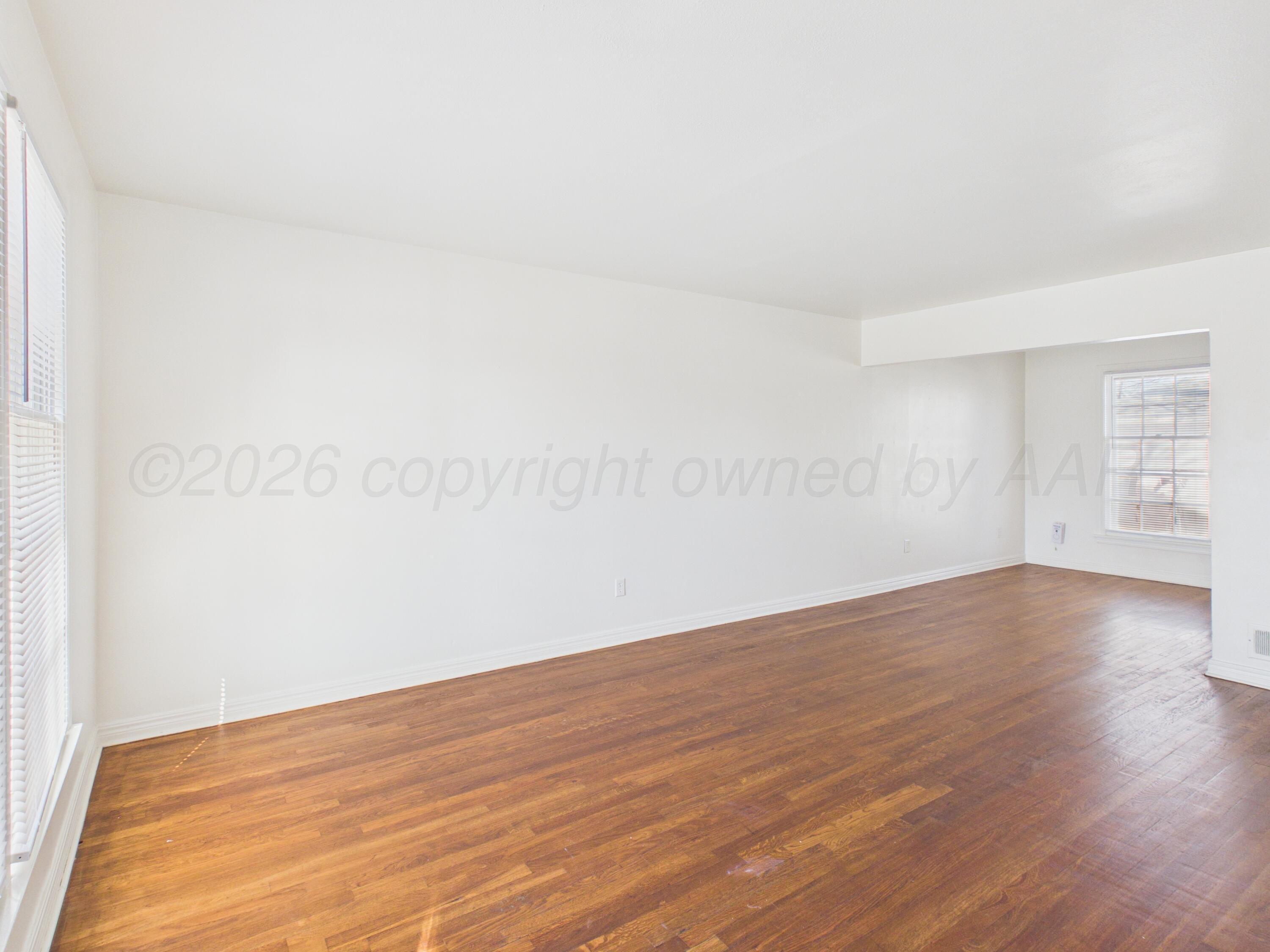 412 Southwest 17th Avenue Amarillo, TX 79102 - Photo 5 of 22 a view of an empty room with wooden floor and a window