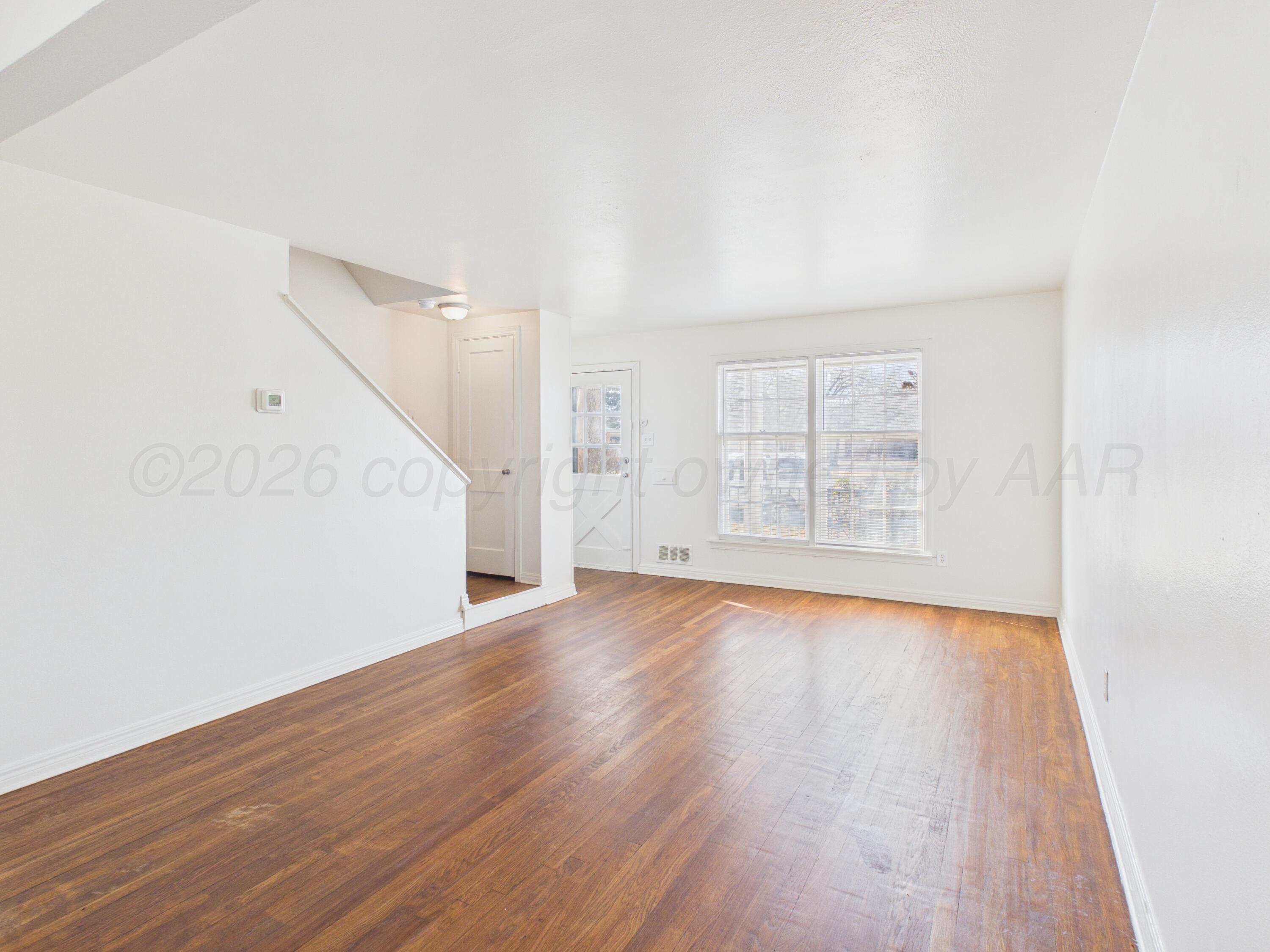 412 Southwest 17th Avenue Amarillo, TX 79102 - Photo 7 of 22 an empty room with wooden floor and windows