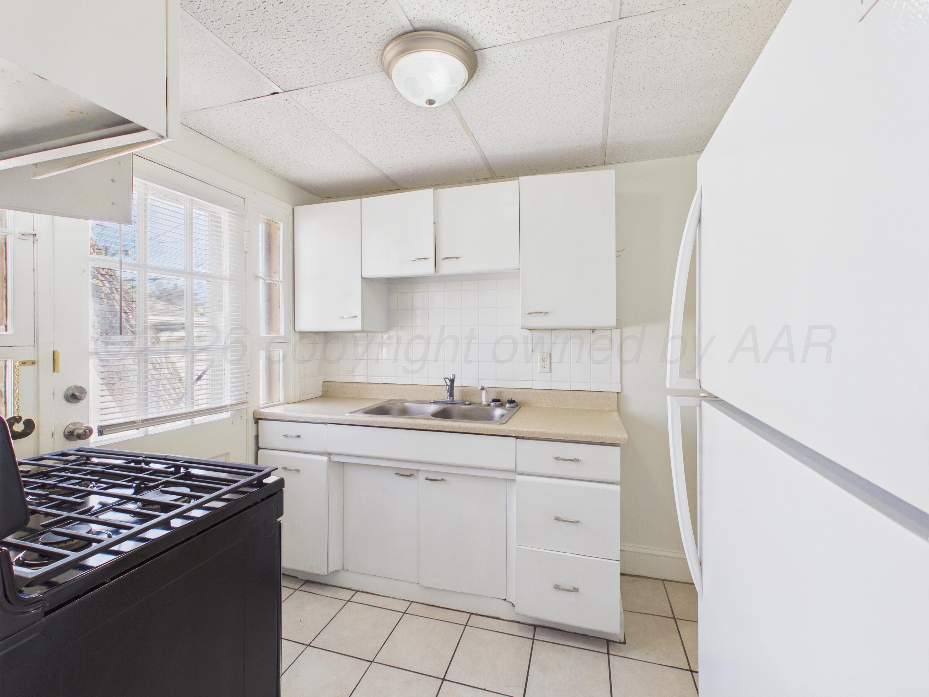 412 Southwest 17th Avenue Amarillo, TX 79102 - Photo 9 of 22 a kitchen with white cabinets and appliances