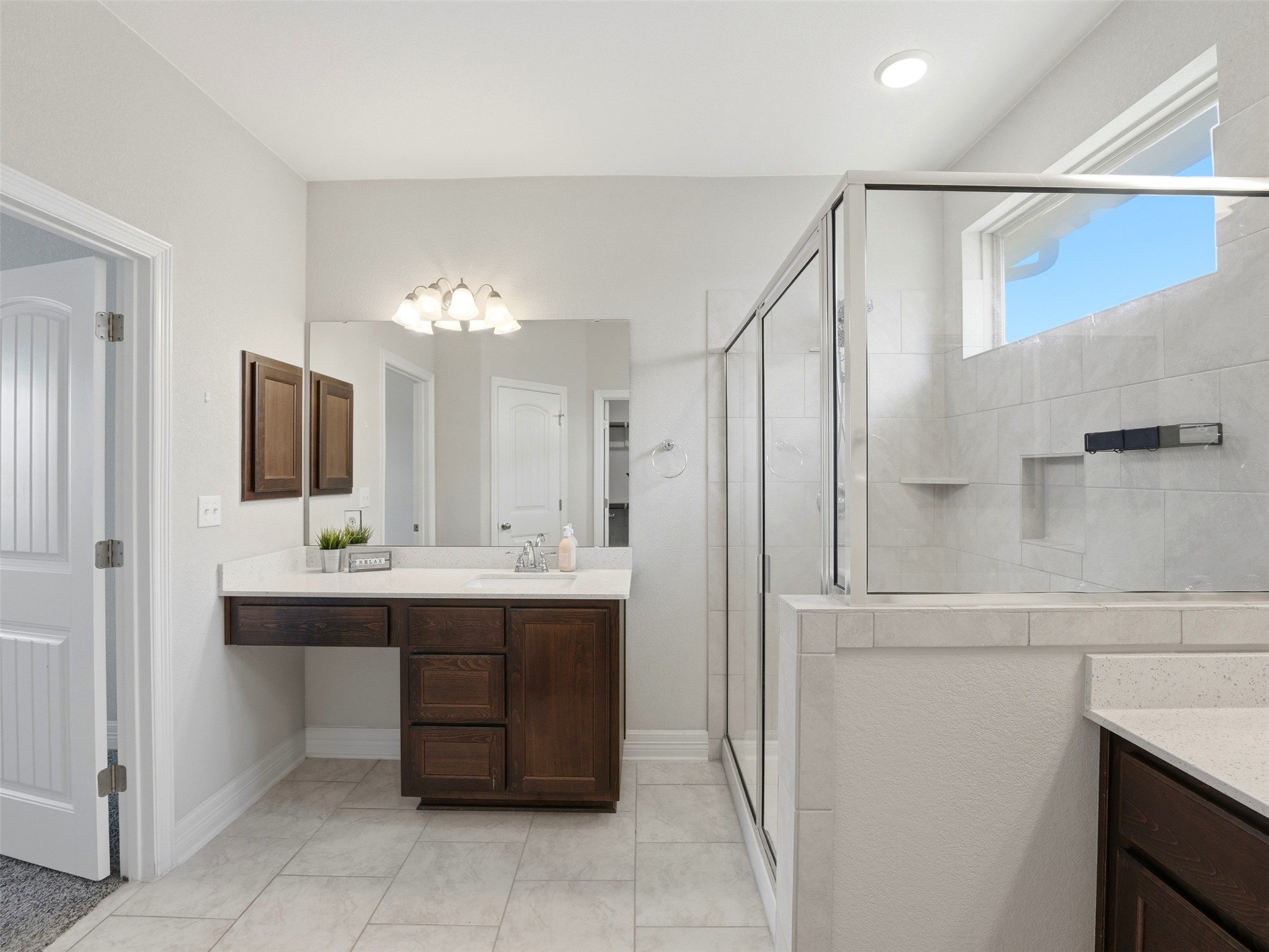 2132 Ringstaff Road Leander, TX 78641 - Photo 25 of 39 A well-appointed bath boasts ample counter space, a spacious walk-in shower, and stylish tile flooring.