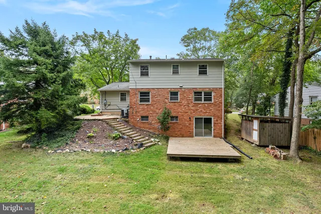 a view of a house with a yard patio and fire pit