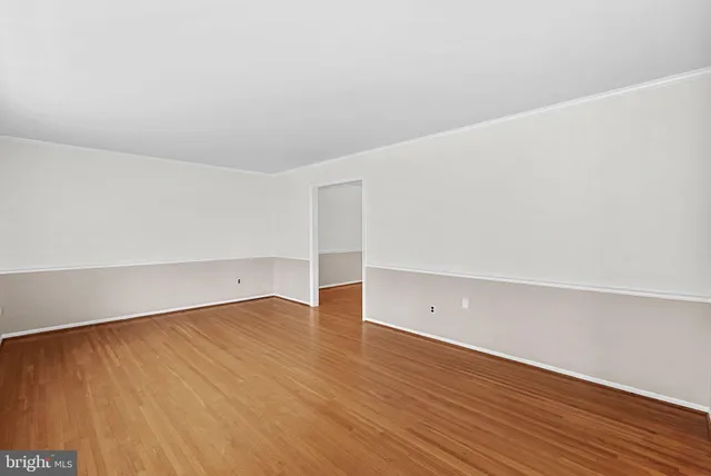 an empty room with wooden floor