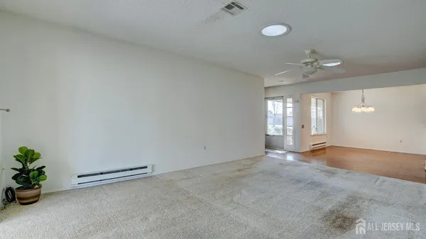 an empty room with windows and closet