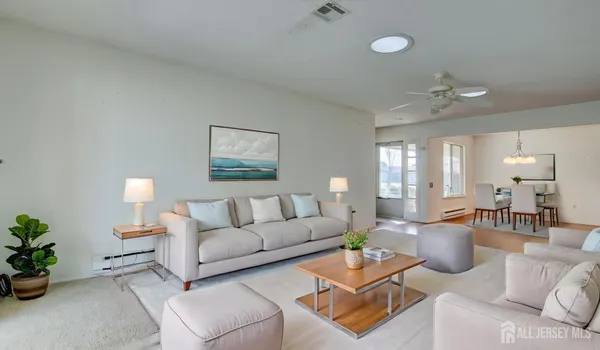 a living room with furniture a lamp and a chandelier