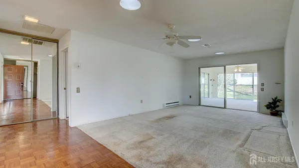 a view of an empty room with glass door