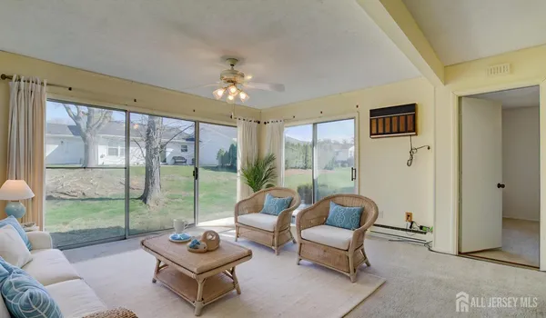 a living room with furniture and a floor to ceiling window