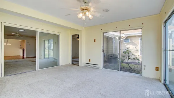 a view of entryway and hall with a ceiling fan