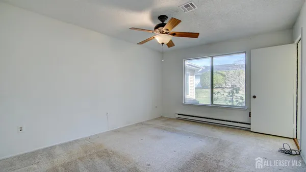 a view of room with a ceiling fan and window