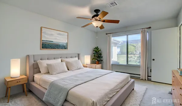 a bedroom with a large bed and a chandelier