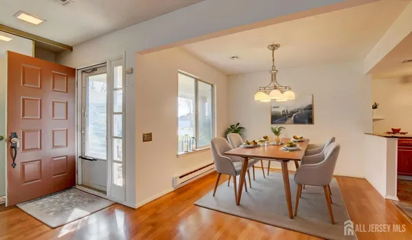 a view of a dining room with furniture window and wooden floor