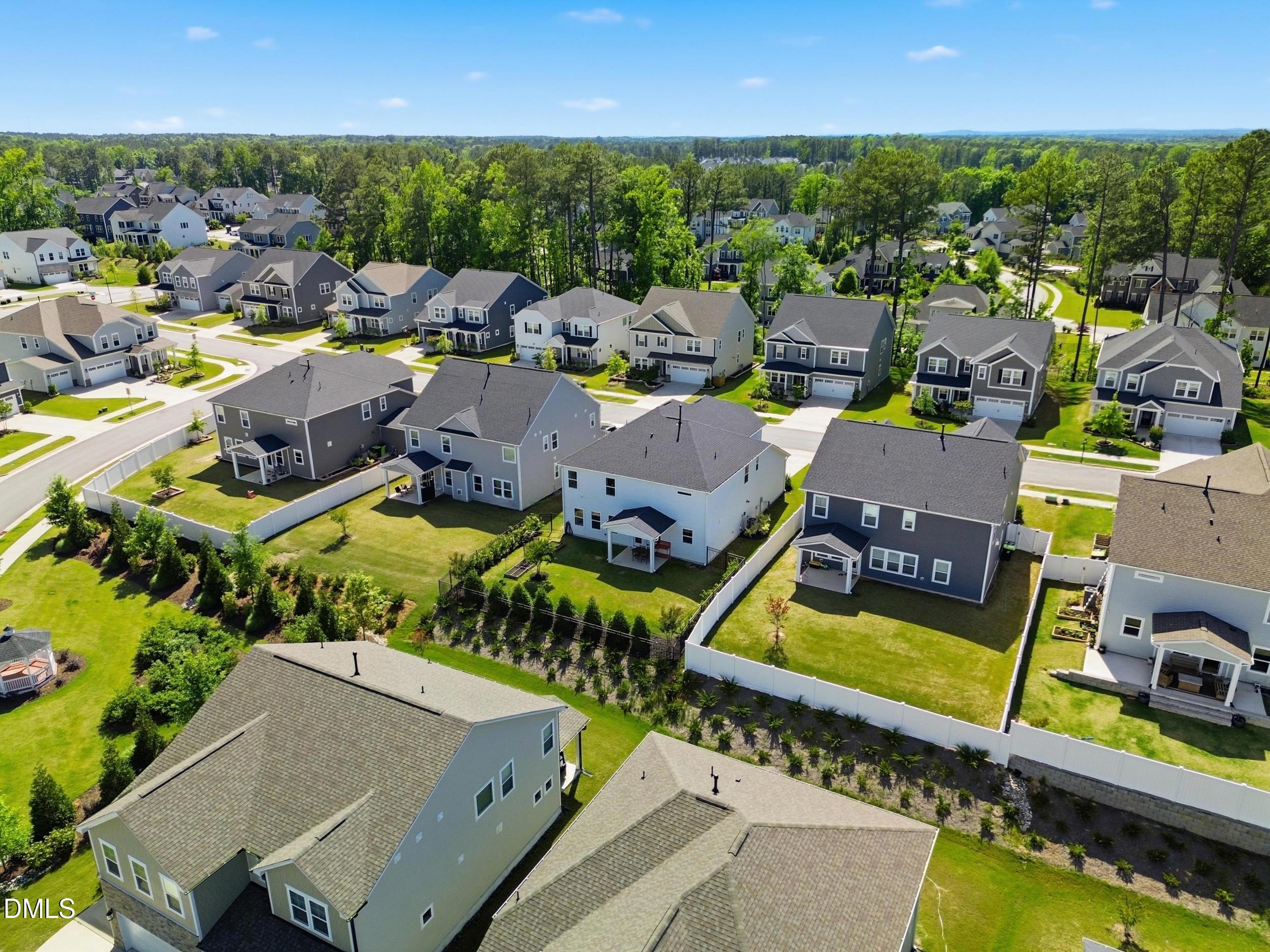 2709 Womble Ridge Drive New Hill, NC 27562 - Photo 52 of 60 an aerial view of a house with a garden and lake view