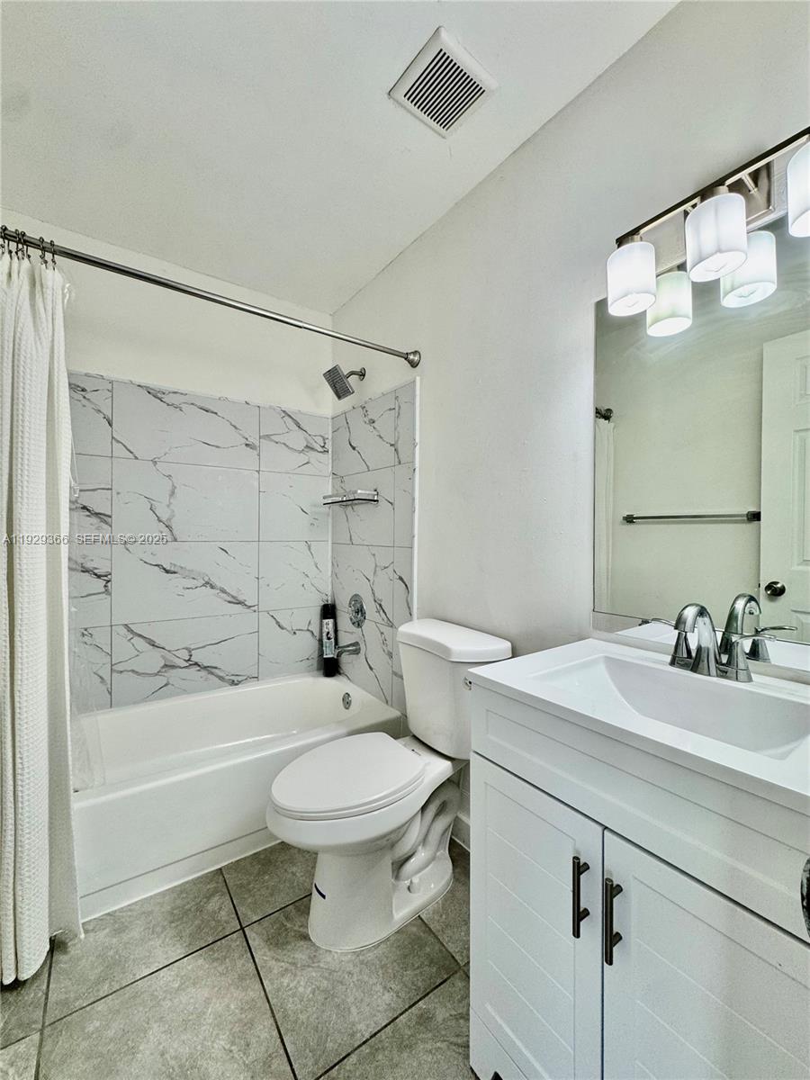 22205 Southwest 103rd Avenue, Unit 22205 Cutler Bay, FL 33190 - Photo 12 of 16 a bathroom with a sink toilet and shower