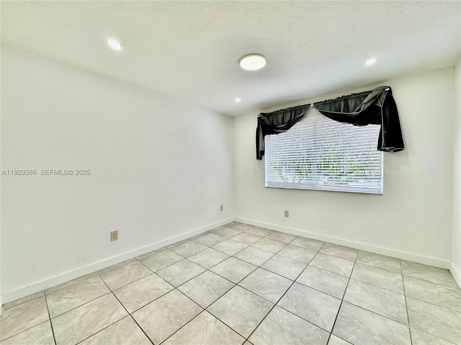 22205 Southwest 103rd Avenue, Unit 22205 Cutler Bay, FL 33190 - Photo 9 of 16 a view of a room with wooden floor and cabinets
