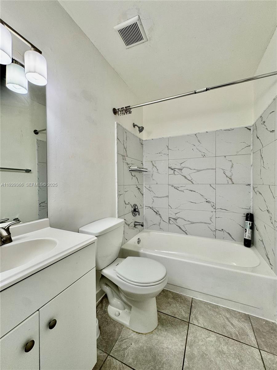 22205 Southwest 103rd Avenue, Unit 22205 Cutler Bay, FL 33190 - Photo 10 of 16 a bathroom with a sink toilet and shower