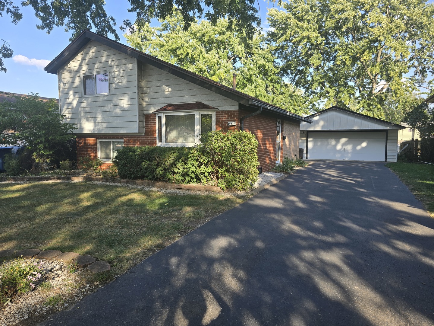 14431 Tripp Avenue Midlothian, IL 60445 - Photo 1 of 14 a front view of a house with garden