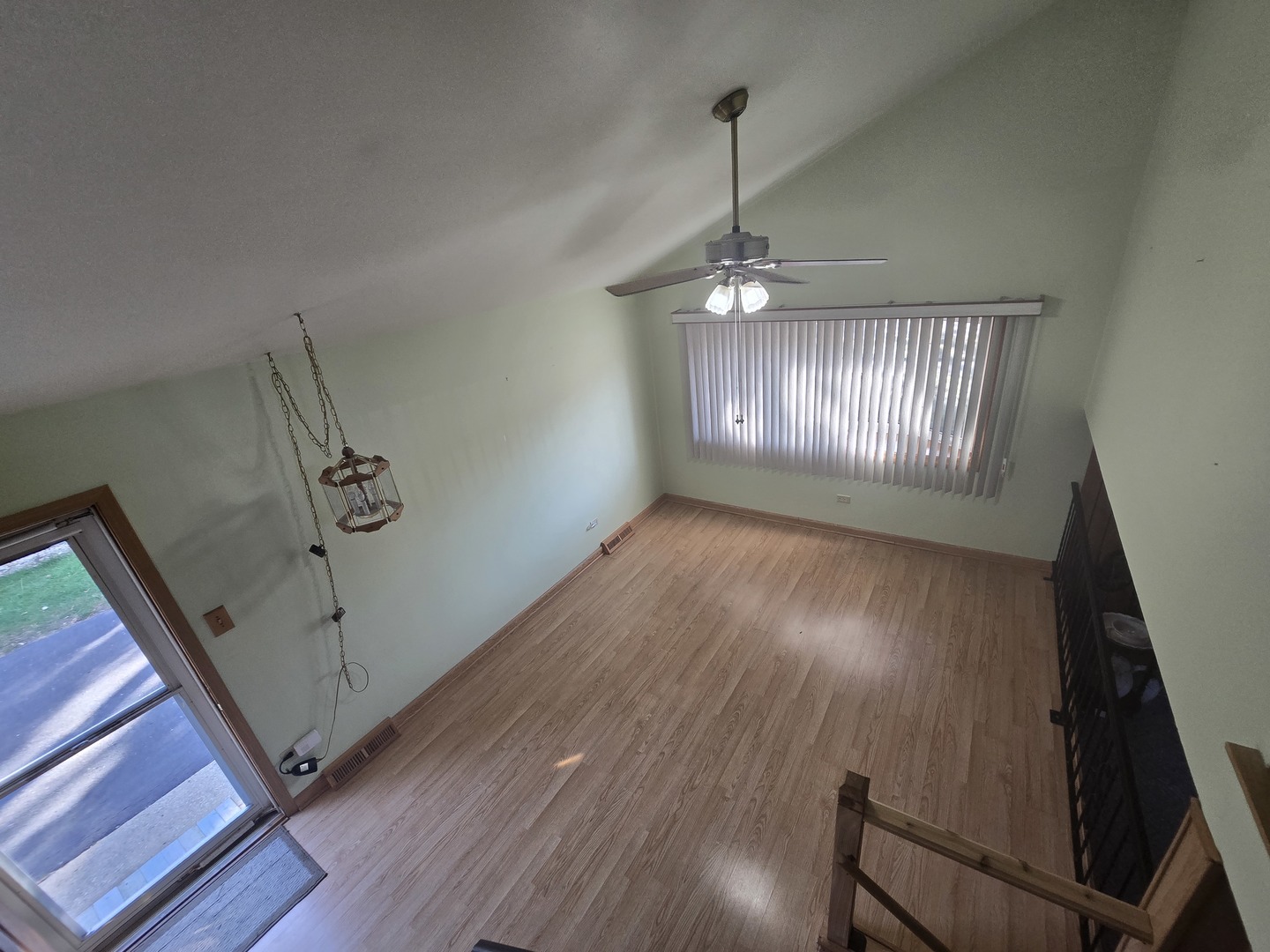 14431 Tripp Avenue Midlothian, IL 60445 - Photo 3 of 14 a view of an empty room with wooden floor and a window