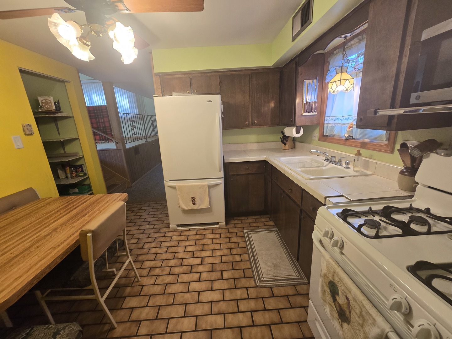 14431 Tripp Avenue Midlothian, IL 60445 - Photo 8 of 14 a kitchen with a sink a refrigerator and cabinets
