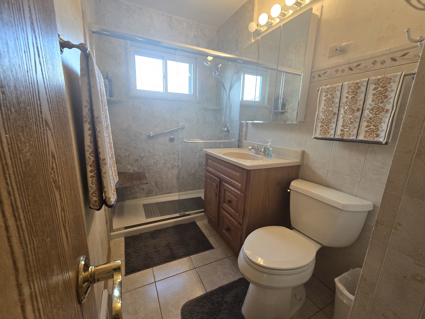 14431 Tripp Avenue Midlothian, IL 60445 - Photo 9 of 14 a bathroom with a sink a toilet and shower