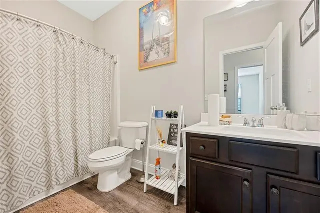 a bathroom with a sink toilet and a mirror