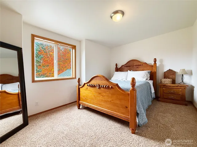 a front view of a house with garden and trees