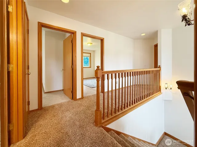 a kitchen with stainless steel appliances granite countertop a refrigerator a sink dishwasher a stove and a dining table with wooden floor