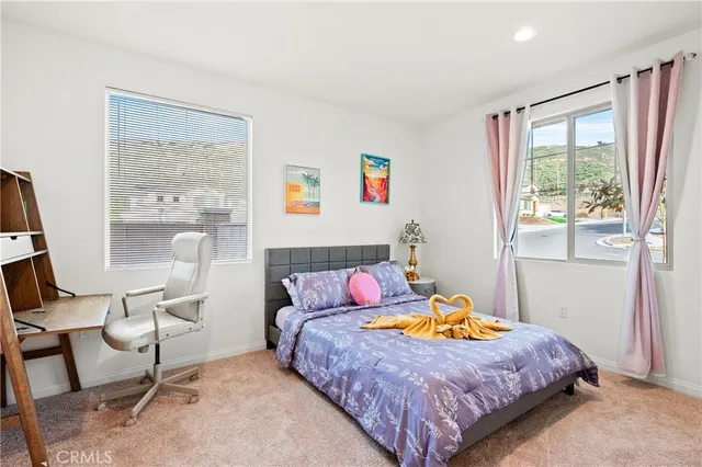 a kitchen with stainless steel appliances a dining table chairs refrigerator and sink