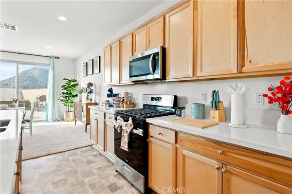 a living room with furniture and a view of kitchen