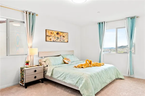 a bedroom with a bed and lamp