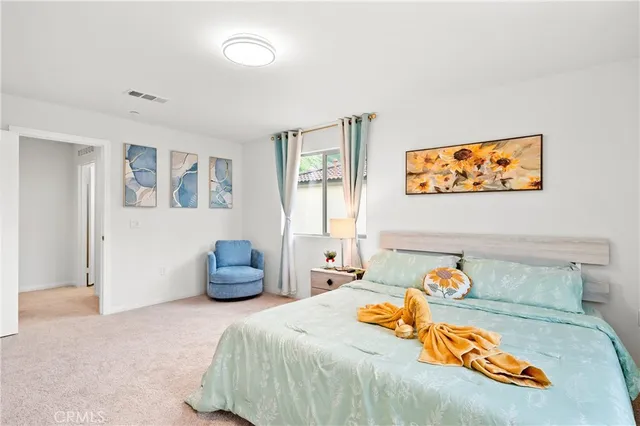 a bedroom with a bed and a large mirror