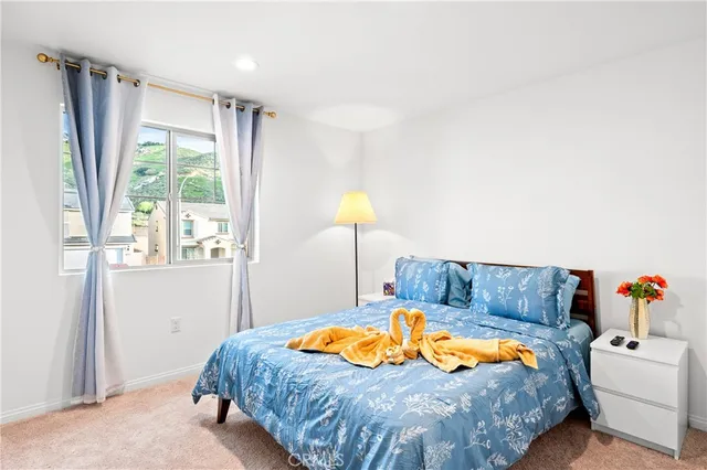 a bedroom with a bed and a couch