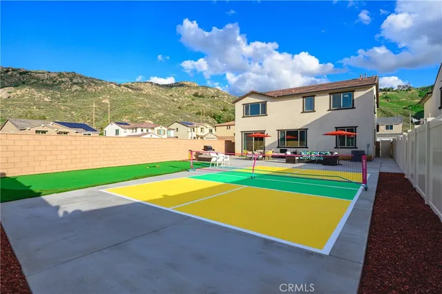 a view of a patio with a table and chairs under an umbrella