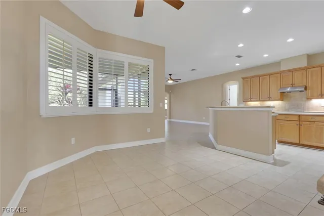 a view of an empty room with a ceiling fan