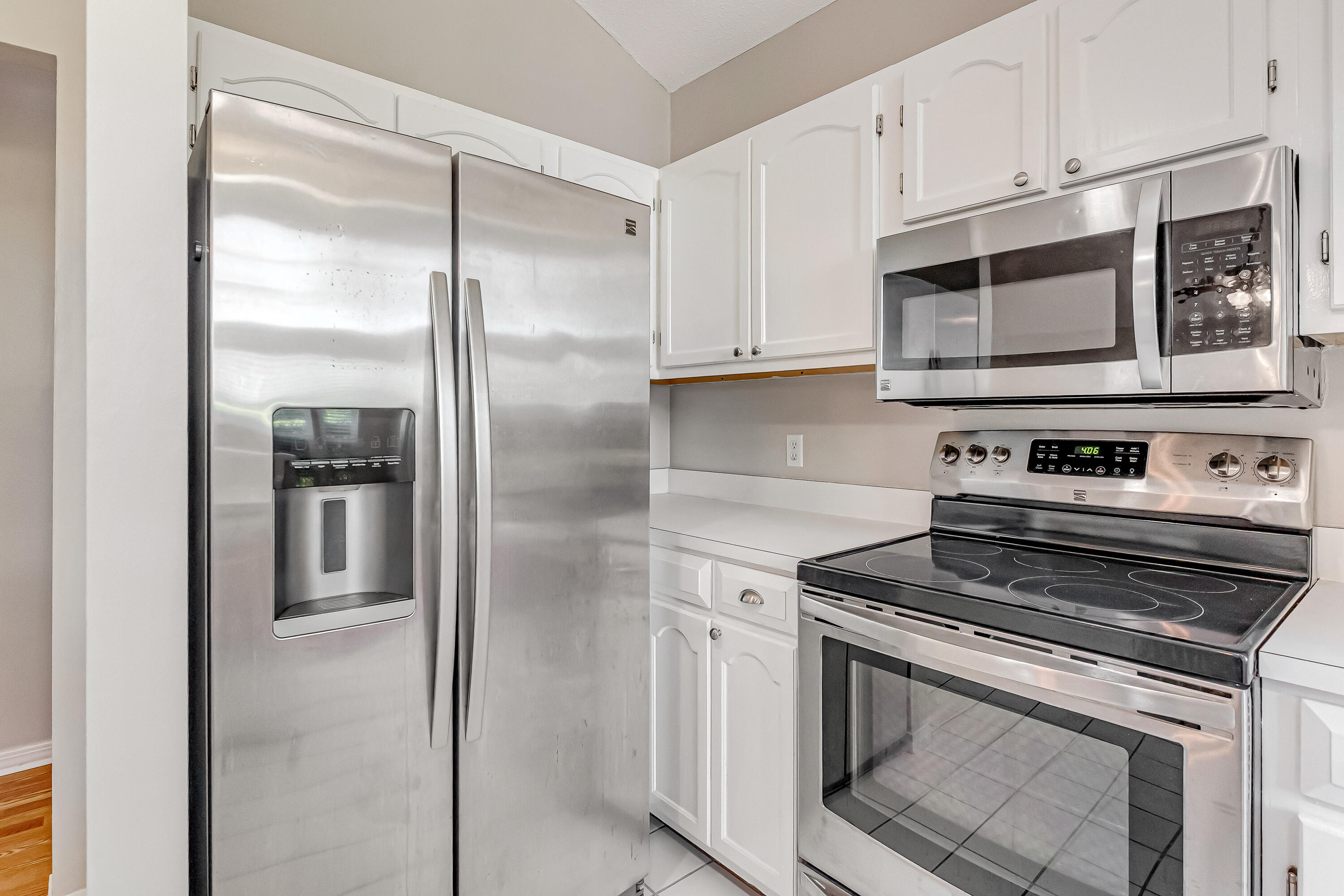 901 Shalimar Cove Shalimar, FL 32579 - Photo 19 of 63 a kitchen with stainless steel appliances granite countertop a stove and a refrigerator with white cabinets