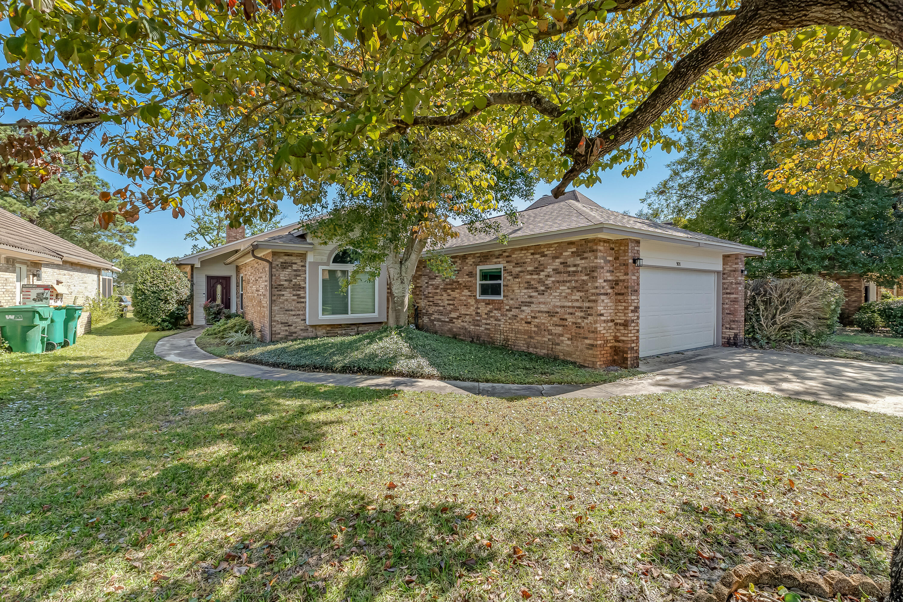 901 Shalimar Cove Shalimar, FL 32579 - Photo 2 of 63 a backyard of a house with plants and large tree
