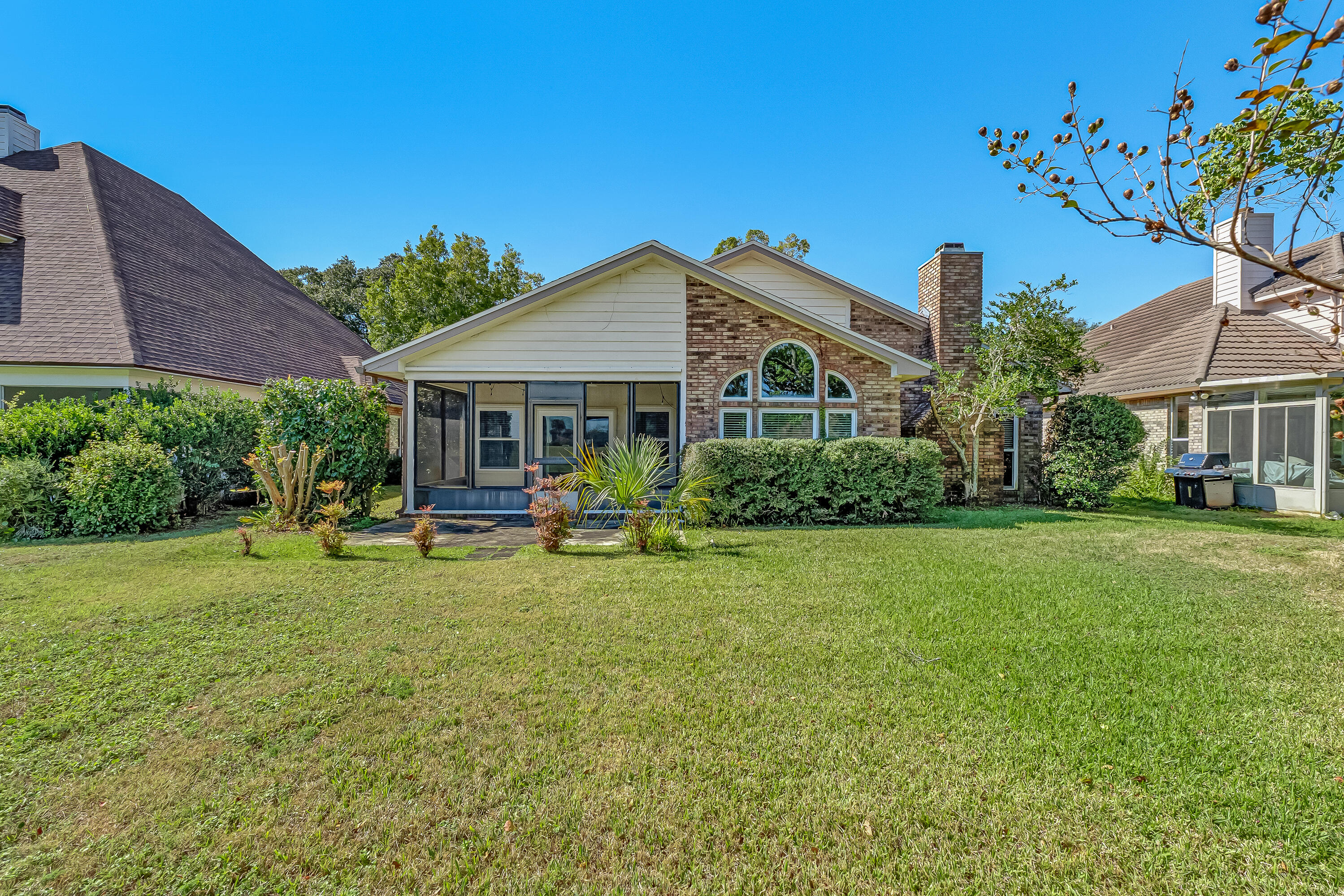 901 Shalimar Cove Shalimar, FL 32579 - Photo 55 of 63 a view of a house with a big yard potted plants and large tree