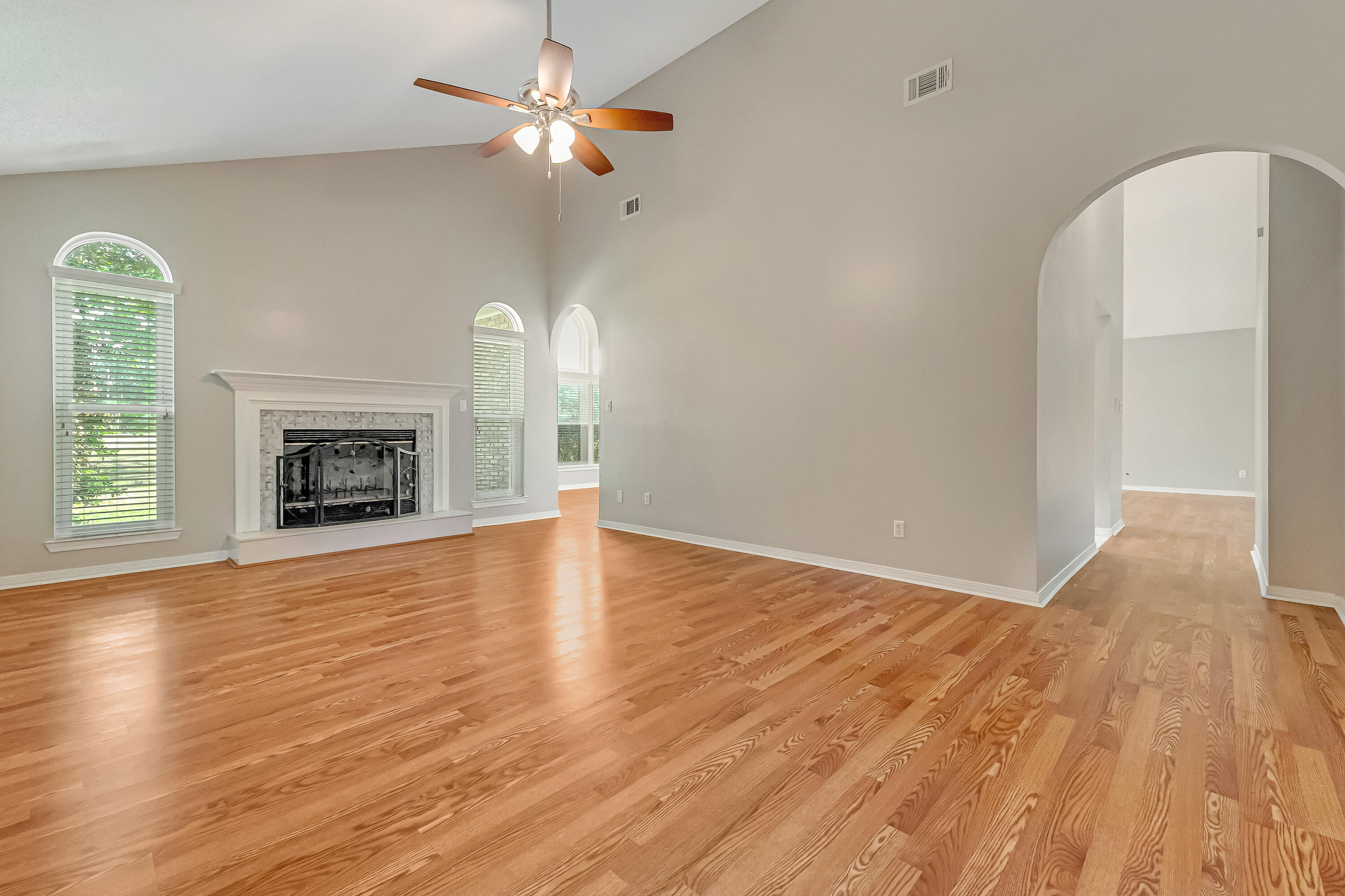 901 Shalimar Cove Shalimar, FL 32579 - Photo 6 of 63 an empty room with wooden floor fireplace and windows