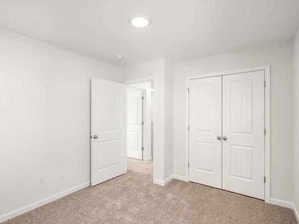 an empty room with closet area