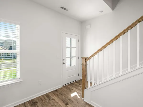 a view of an entryway with wooden floor