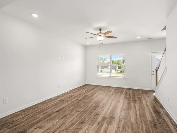 wooden floor in an empty room with a window