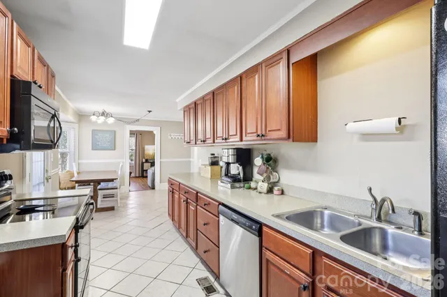 a kitchen with stainless steel appliances granite countertop a sink stove and cabinets