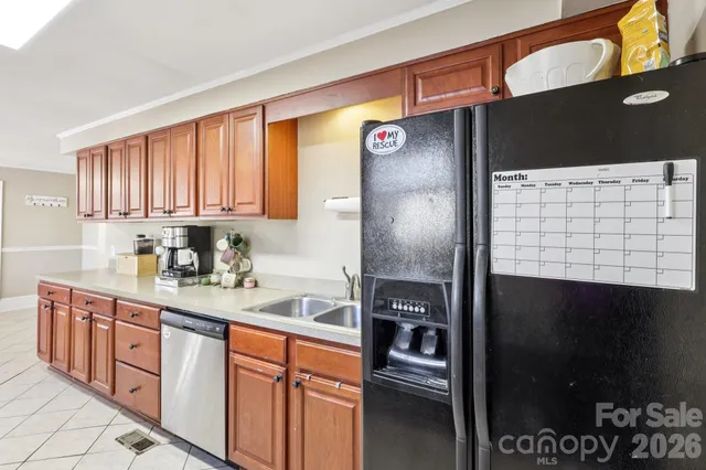 a kitchen with stainless steel appliances granite countertop a refrigerator and a sink