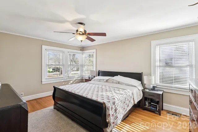 a bed sitting in a bedroom next to a window