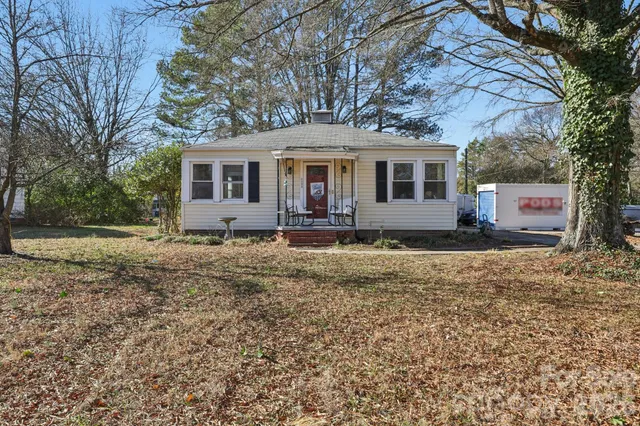 a front view of house with yard and trees