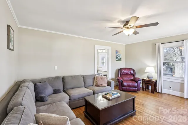 a living room with furniture a rug and a window