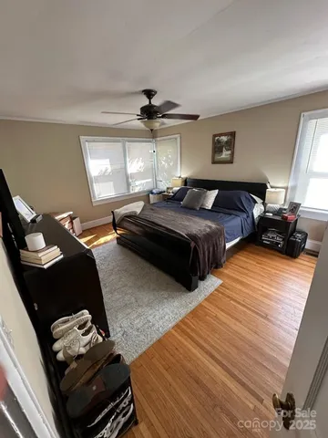 a bedroom with two beds and a chandelier