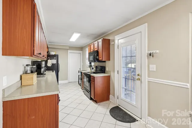 a kitchen with stainless steel appliances granite countertop a refrigerator a stove and a sink with wooden floor